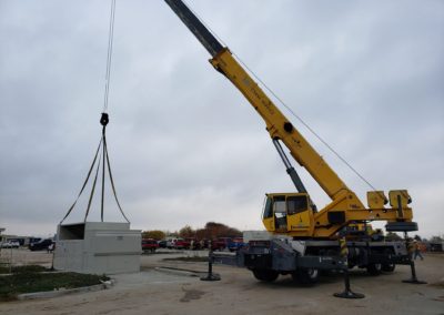 Blue's Crane Service crane lifting heavy machinery.