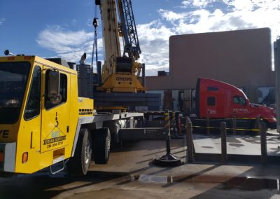 Blue's Crane Service Crane with Blue's Hotshot Service semi on a jobsite.