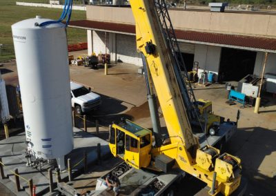 View from above of Blue's Crane Service crane placing a tank.