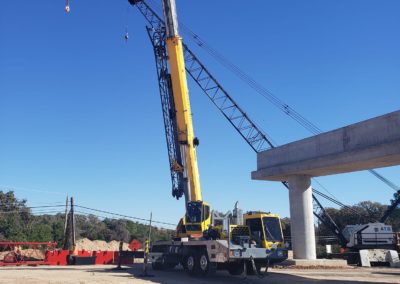 Blue's Crane Service crane with it's boom extended at a jobsite.