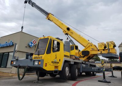 Blue's Crane Service crane performing a lift at Domino's Pizza.