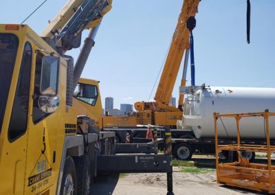 Blue's Crane Service crane ready to lift some tanks.