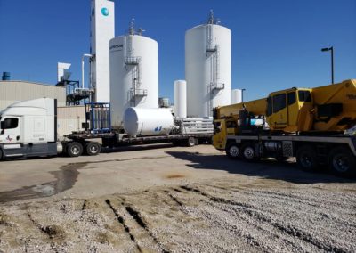 Blue's Crane Service crane on a jobsite preparing to make some lifts off of a flatbed trailer.