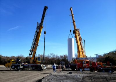 Two cranes performing lifts side by site at a jobsite for Blue's Crane Service.