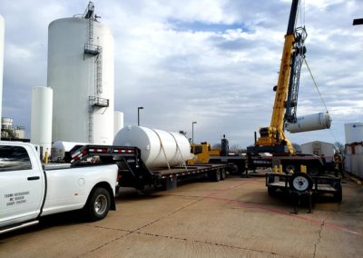 Blue's Crane Service crane lifting a tank.