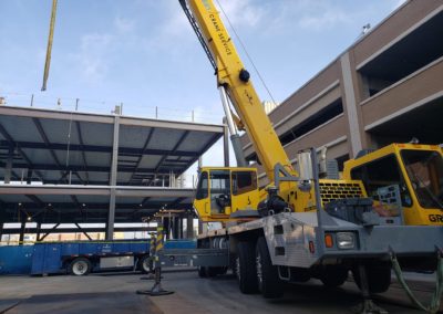 Blue's Crane Service crane performing heavy lifts at a construction site.