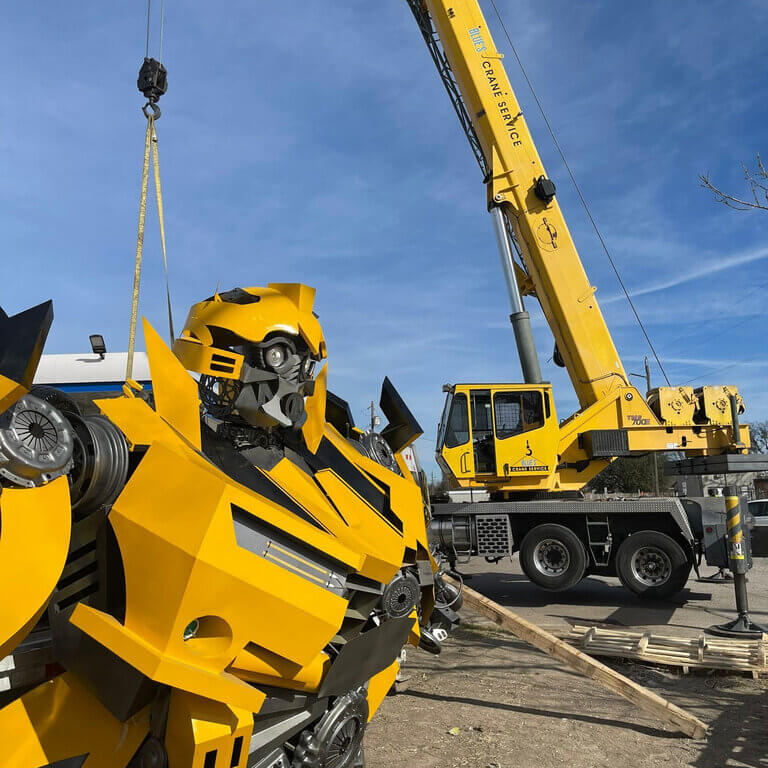 A Blue's Crane Service crane lifting a transformer.