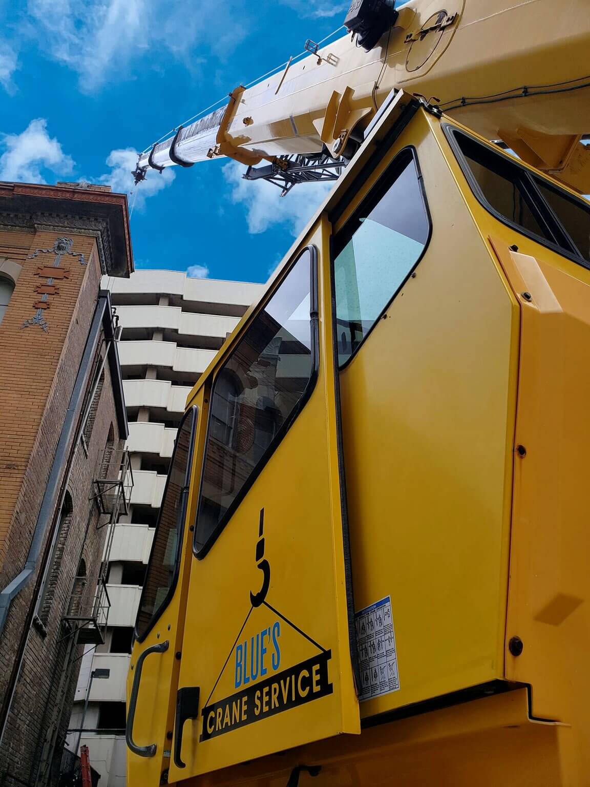 Blue's Crane Service crane performing a lift in downtown Dallas.