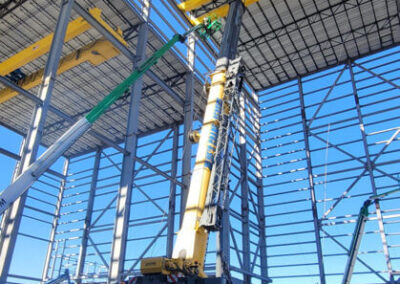 Blue's Crane Service crane working from within a structure.